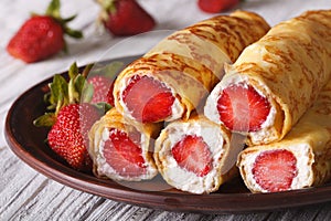Crepes with fresh strawberries and cream cheese close-up