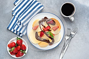 Crepes or pancakes with strawberries and chocolate