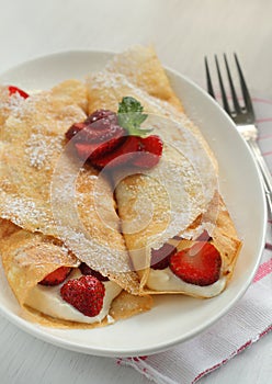 Crepes with strawberry jam and cream