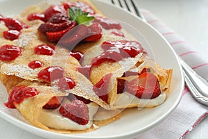 Crepes with strawberry jam and cream