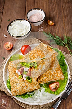 Crepes stuffed with Caesar salad, chicken, tomatoes, cheese and lettuce