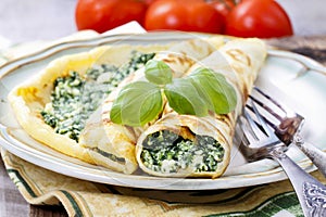 Crepes stuffed with cheese and spinach