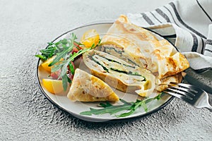 Crepes with stuffed cream cheese, spinach, turkey. Cuisine meal food concept. Closeup