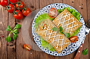 Crepes stuffed with stewed cabbage with carrots and eggs