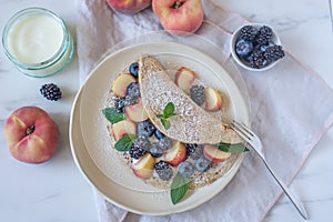 Crepes, thin pancakes or blini with berries
