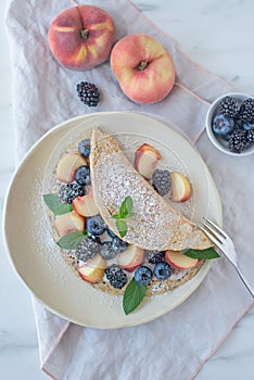 Crepes, thin pancakes or blini with berries