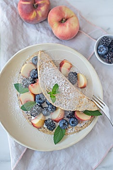Crepes, thin pancakes or blini with berries