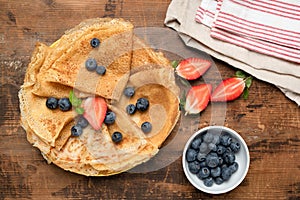 Crepes, thin pancakes or russian blini with fresh berries