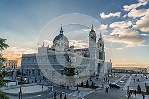 Crepuscular rays or Sunbaems sunset view of Madrid Cathedral Santa Maria la Real de La Almudena in Madrid, Spain.