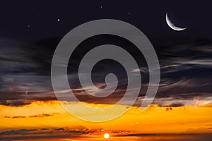 Crescent on the background of sunset