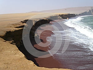 Crescent beach with dark brown sand