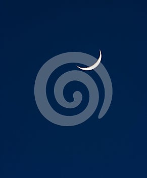 A crescent moon hanging in the night