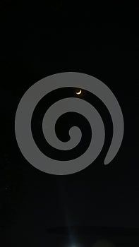 Crescent moon on a moonless night.