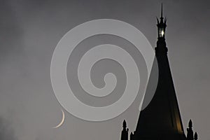 A crescent moon next to the Campanile at U.C. Berkeley. photo