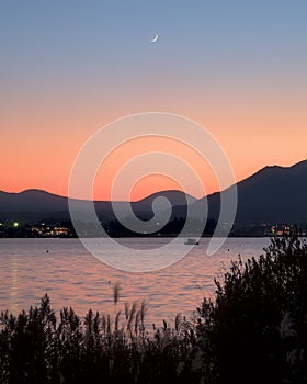 A crescent moon rising over Lake Kawaguchi