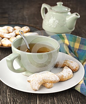 Crescents vanilla and almond cookies and cup of green tea