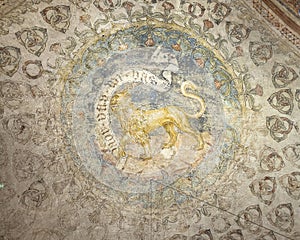 Crest with a lion painted on the ceiling vault of the Ring Room in the Fortress of Vignola, Italy.