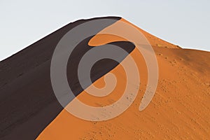 The crest of a red dune in the Namib Desert, in Sossusvlei, Namibia