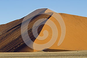 The crest of a red dune in the Namib Desert, in Sossusvlei, Namibia