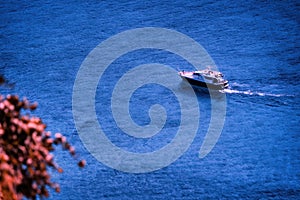 Creta, Greece- September 15, 2017: Aerial drone shot of a ship sailing with passenger near the fortress of Gramvousa in Kreta