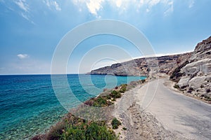 Cretan road along the coast of Crete island with beautiful lagoon and mountains