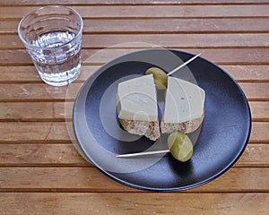 Cretan rusks with local gruyere cheese, olives and a glass of raki