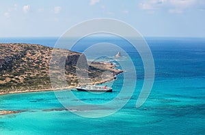Crete coast, Balos bay, Greece. The ship is going on the marvelous turquoise sea. Popular touristic resort. Summer scenic.