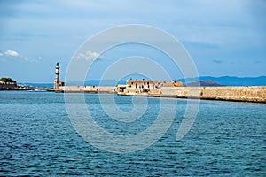 Crete Greece. Lighthouse, beacon at Venetian harbour in Old Town of Chania. Sunny day