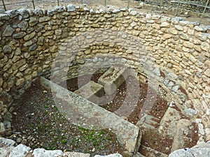 Crete, Greece - November, 2017: Pit for sacrifices, laid out with stones, the west courtyard of the Knossos palace