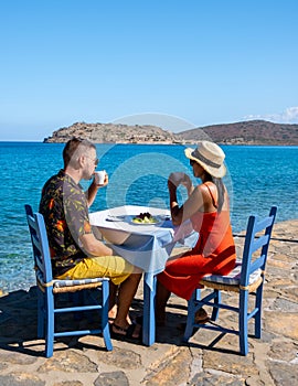 Crete Greece Plaka Lassithi with is traditional blue table and chairs and the beach in Crete Greece. photo