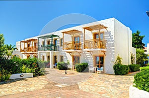 CRETE ISLAND, GREECE, JULY 01, 2011: View on Aldemar hotel villa among colorful flowers for tourists guests. Classical Greek hotel
