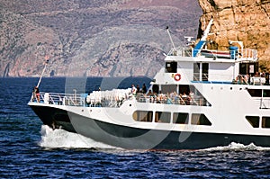 Crete or Kreta, Greece - September 15, 2017: Spirit of Athos ship passenger vessel sailing in the mediterranean sea against rocky