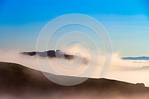 Crete Senesi landscape in Tuscany, Italy on a foggy dawn