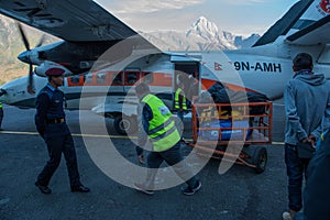 Crew of airline manage bags and passengers with police at Lukla airport