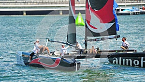 Crew of Alinghi team steering boat at Extreme Sailing Series Singapore 2013