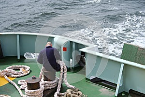 Crew member with thick rope photo