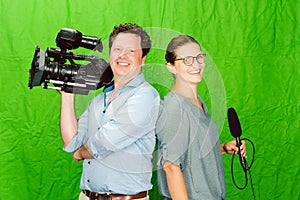 Crew of reporter and cameraman posing in the studio