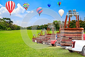 The crews transportation Hot Air Balloon on car after landing with against background balloon flying on blue sky