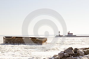 The Crib and lighthouses on pier along shipping channel on froze