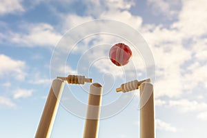 Cricket ball hitting wicket stumps and bails background photo