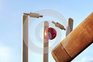 Cricket ball hitting wicket stumps knocking bails out