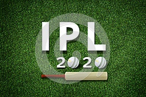 Cricket bat and leather ball resting on a cricket bat with ipl 2020 text placed on green grass cricket ground pitch,ipl 2020 india