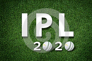 Cricket bat and leather ball resting on a cricket bat with ipl 2020 text placed on green grass cricket ground pitch,ipl 2020 india