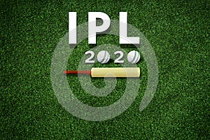 Cricket bat and leather ball resting on a cricket bat with ipl 2020 text placed on green grass cricket ground pitch,ipl 2020 india