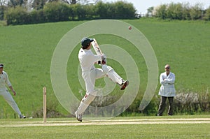 A Cricket batsman hitting the ball photo