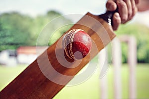 Cricket player hitting ball