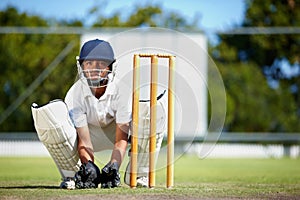 Cricket, sports and a man as wicket keeper on a pitch for training, game or competition. Male athlete behind stumps with