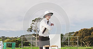 Cricket umpire making signs standing on a cricket pitch