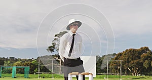 Cricket umpire making signs standing on a cricket pitch