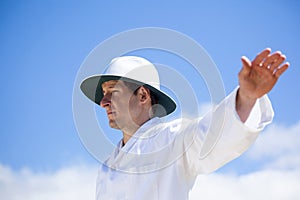 Cricket umpire signalling a boundary